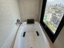 Modern bathroom with city view through a large window
