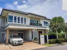 Modern two-story house with balcony and carport