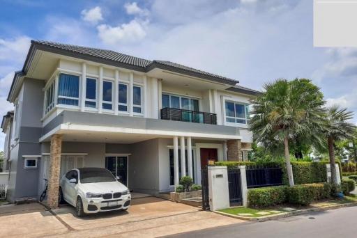 Modern two-story house with balcony and carport