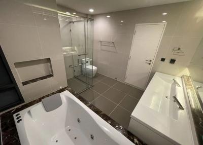 Modern spacious bathroom with a jacuzzi tub and glass shower enclosure