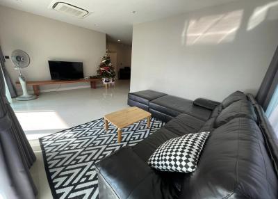Modern living room interior with comfortable sofa and Christmas tree