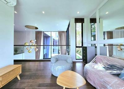 Modern living room with large windows and hardwood floors