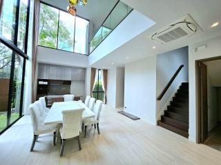 Spacious modern dining and living area with high ceiling and large windows