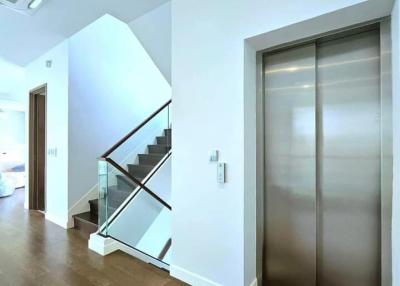 Modern hallway with stairs and an elevator