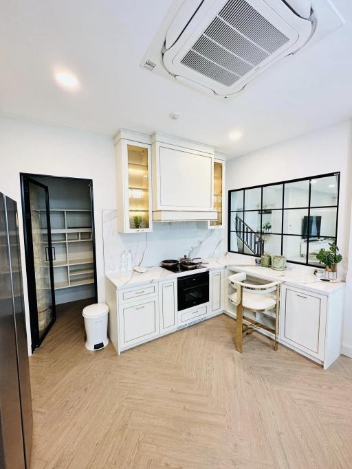 Modern kitchen with stainless steel appliances and marble countertops