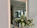 Elegant interior with ornate mirror over a marble console table with decorative items