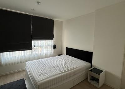 Modern bedroom with a large bed and natural light