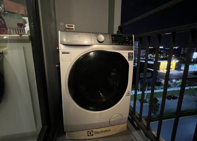 Washing machine on a balcony with nighttime view