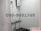 Modern bathroom interior with wall-mounted electric shower unit