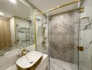 Modern bathroom interior with marble finishes and gold accents