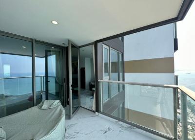 Spacious balcony with ocean view and glass railing