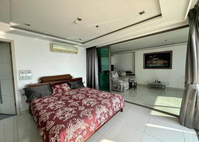 Spacious bedroom with large bed and access to living area