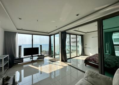 Spacious living room with floor-to-ceiling windows overlooking the ocean