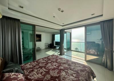 Spacious bedroom with large windows and sea view