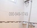 Bright tiled bathroom with shower and water heater