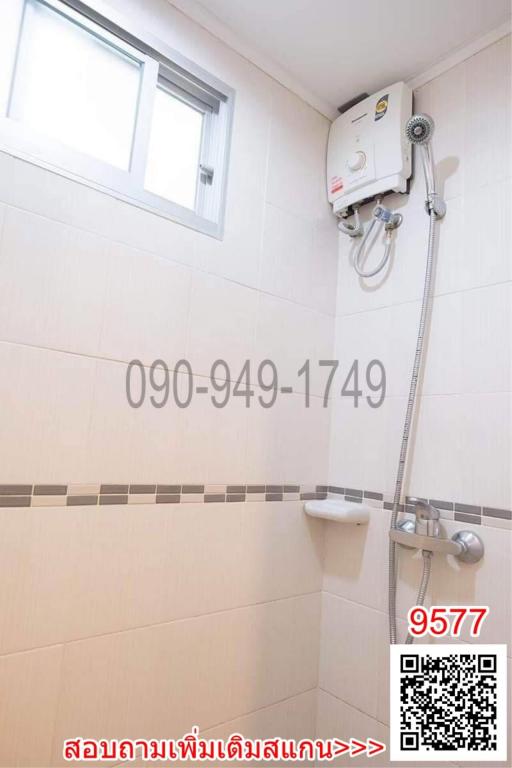 Bright tiled bathroom with shower and water heater