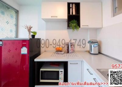 Modern kitchen with red refrigerator and white cabinetry