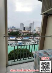 City view from a high-rise balcony with a safety railing