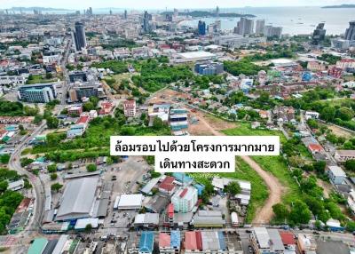 Aerial view of a coastal cityscape with buildings and green areas