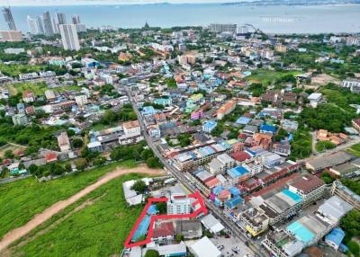 Aerial view of a residential area with property outlined in red