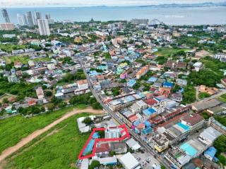 Aerial view of a residential area with property outlined in red