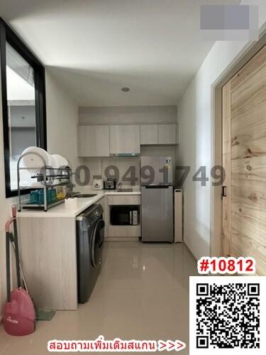 Compact modern kitchen with appliances and light wooden cabinetry