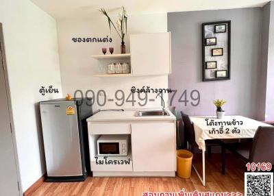 Compact kitchen space with white cabinetry and modern appliances