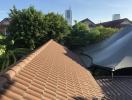 Roofline and skyline view from the property showing nearby structures and vegetation