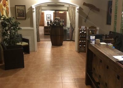 Spacious interior view of a building with archway and tiled flooring