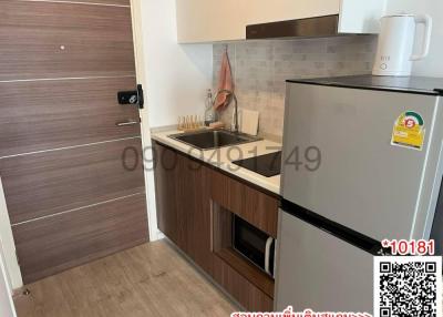 Compact modern kitchen with wooden cabinets and essential appliances