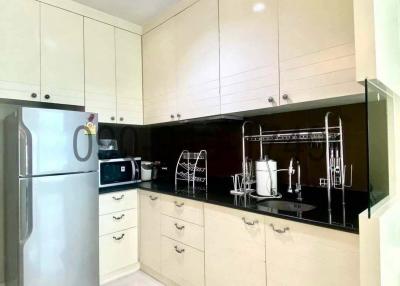 Modern kitchen with white cabinetry and black countertop