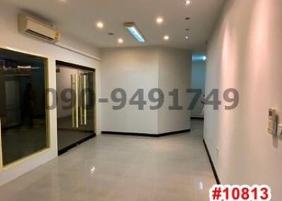 Spacious and well-lit empty room with glossy tiled flooring and recessed lighting