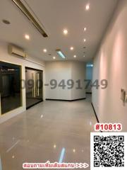 Spacious and well-lit empty room with glossy tiled flooring and recessed lighting