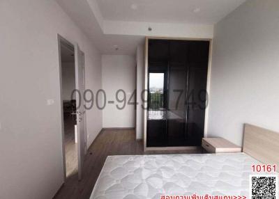 Spacious bedroom with large window and attached balcony
