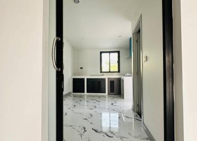 Elegant interior view through an open door featuring marble floors and modern design