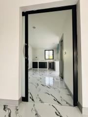 Elegant interior view through an open door featuring marble floors and modern design