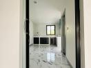 Elegant interior view through an open door featuring marble floors and modern design