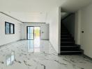 Spacious unfurnished interior of a modern house with marble floors and a staircase