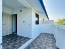 Spacious balcony with patterned floor and clear sky