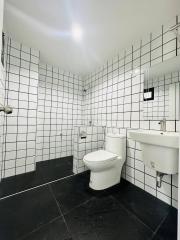 Modern white tiled bathroom with black accents