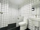 Modern white tiled bathroom with black accents