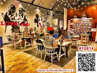 Cozy restaurant interior with patrons and playful wall art