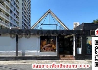 Facade of a modern commercial building with glass entrance and shop signage