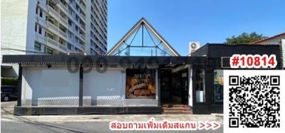 Facade of a modern commercial building with glass entrance and shop signage