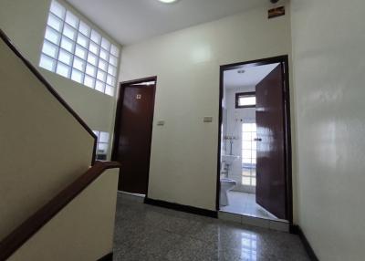 Bright entrance hall with doors to various rooms and staircase to upper level