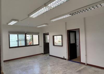 Spacious empty room with tile flooring and large windows providing ample natural light