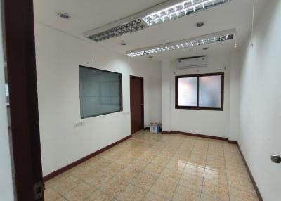 Spacious empty room with tiled flooring and ample lighting
