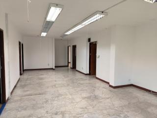 Spacious empty interior of a building with tiled flooring and natural light