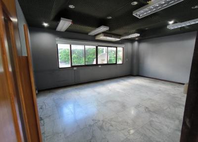 Spacious unfurnished interior of a modern building with large windows and marble flooring