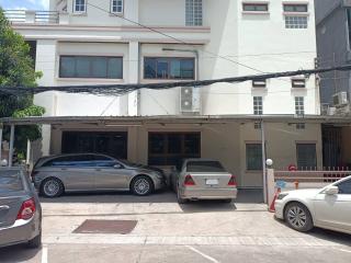 Exterior view of a residential building with parked cars